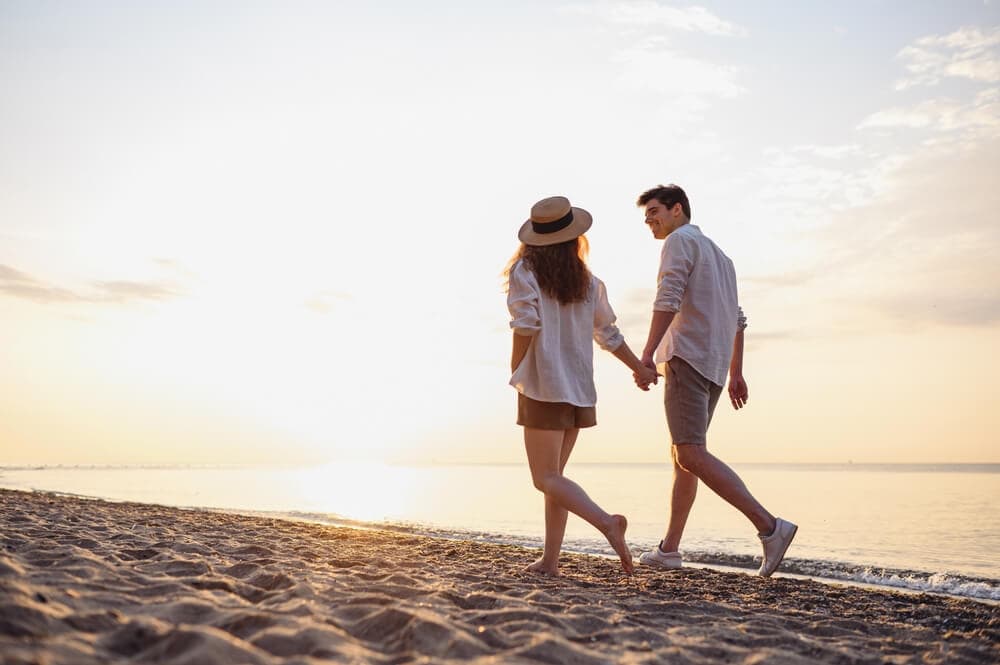 A couple walking on the beach on their Florida summer vacation near Sarasota.